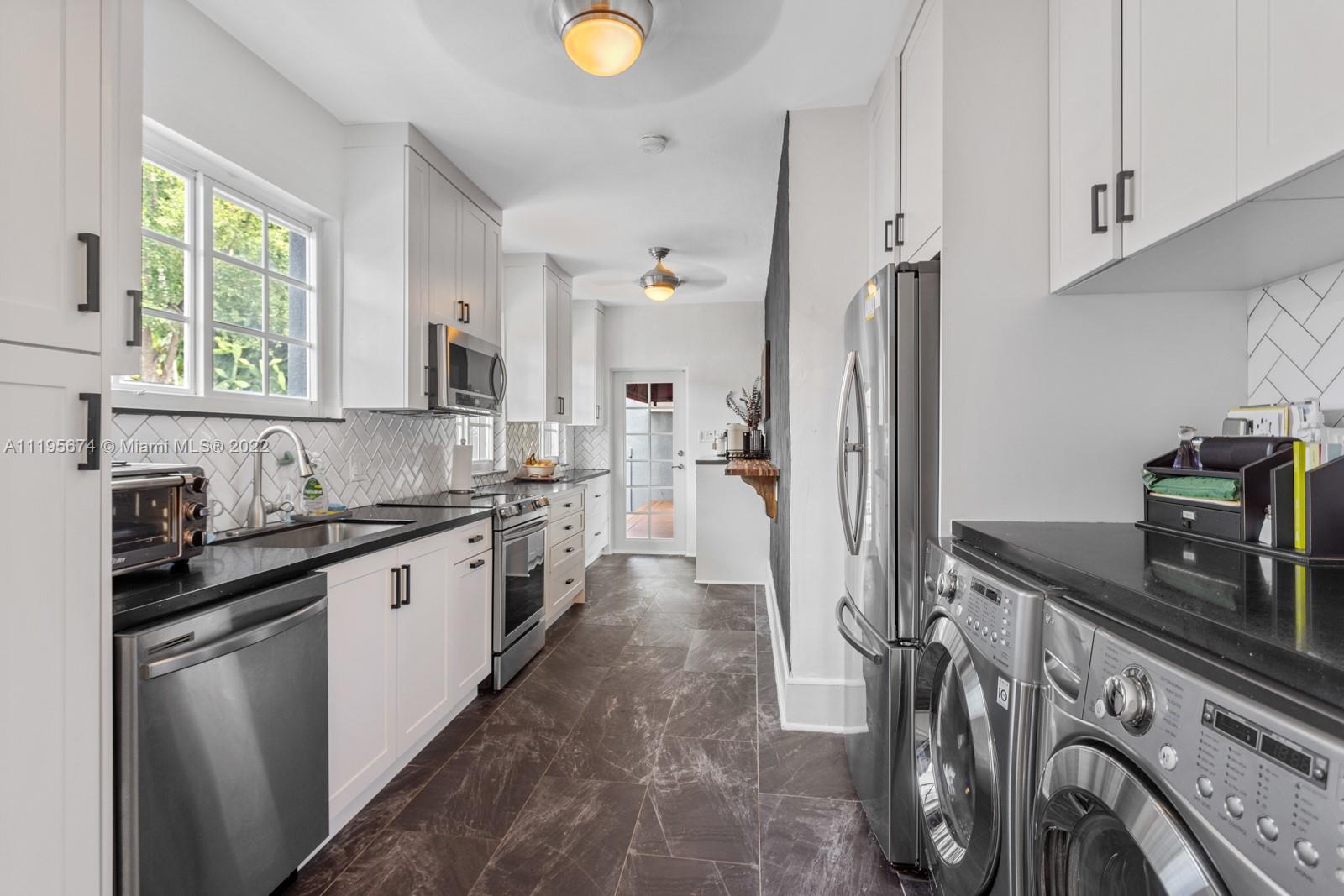 1860 Southwest 11th Street Miami, FL 33135 - Photo 11 of 30 a kitchen with stainless steel appliances granite countertop a sink stove and refrigerator