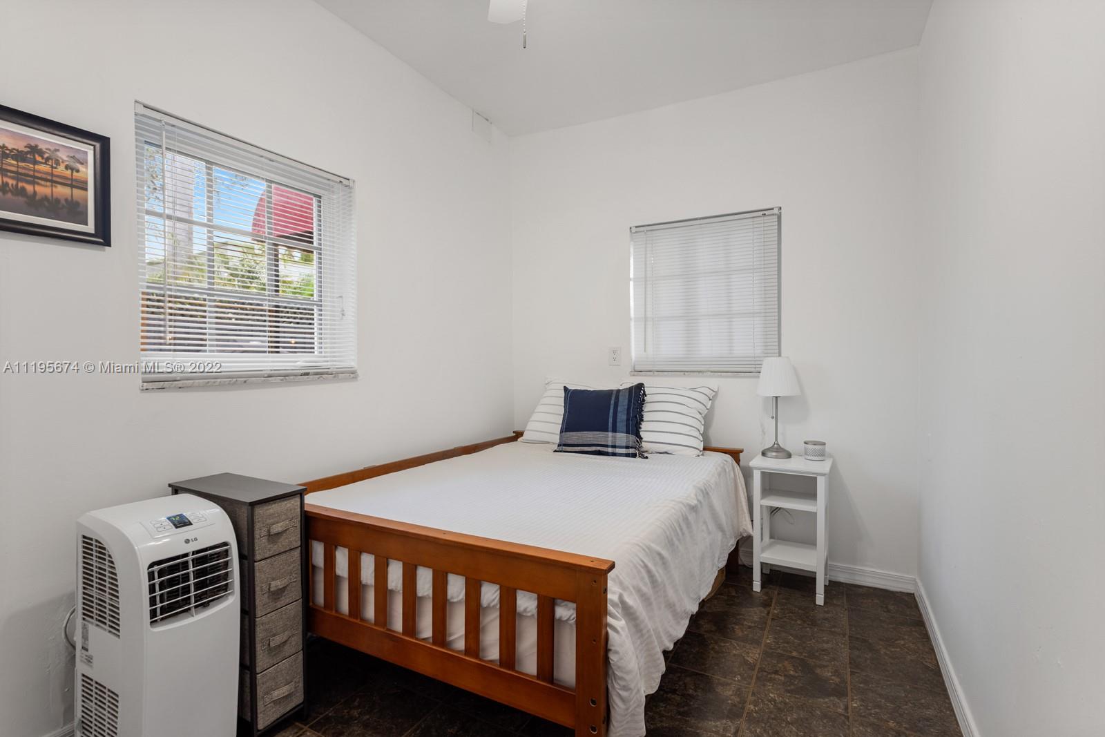 1860 Southwest 11th Street Miami, FL 33135 - Photo 20 of 30 a bedroom with a bed and a window