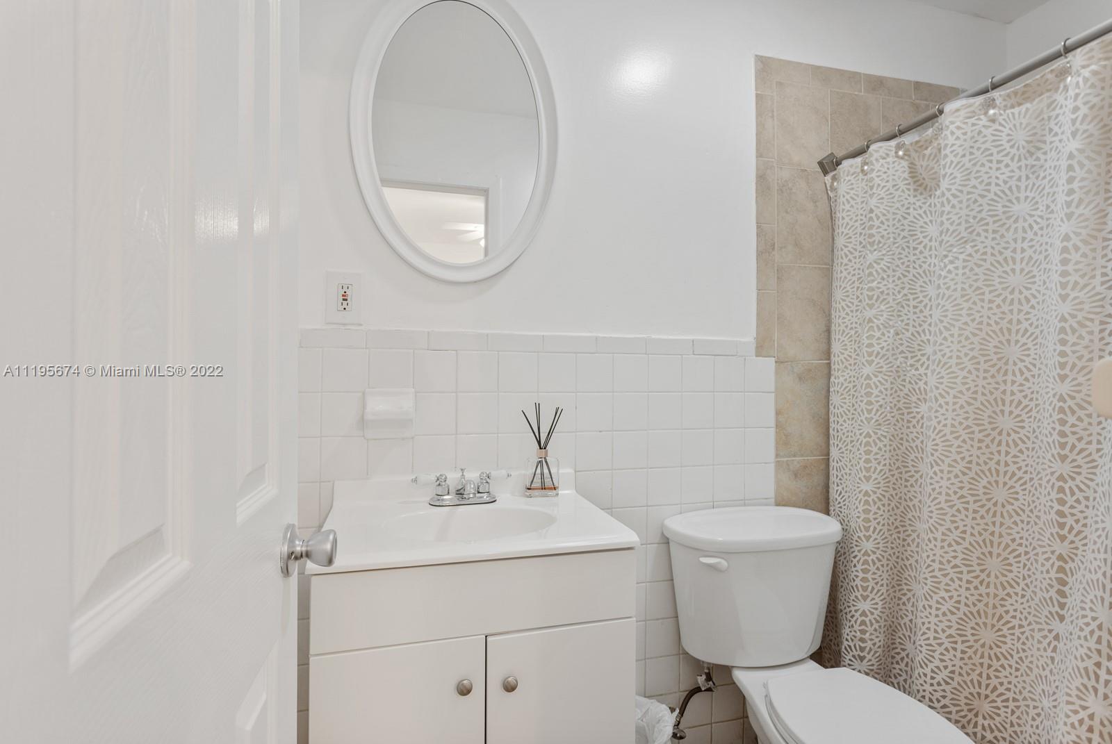 1860 Southwest 11th Street Miami, FL 33135 - Photo 21 of 30 a bathroom with a sink a toilet and a mirror