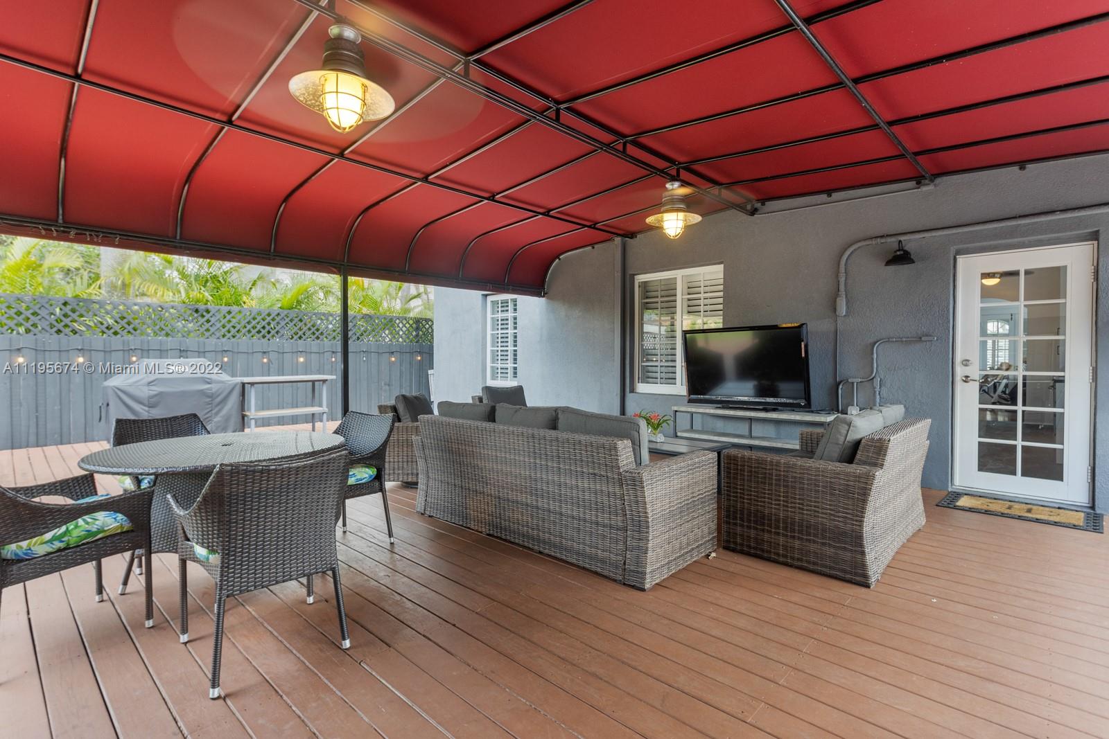 1860 Southwest 11th Street Miami, FL 33135 - Photo 24 of 30 a living room with furniture a flat screen tv and floor to ceiling window