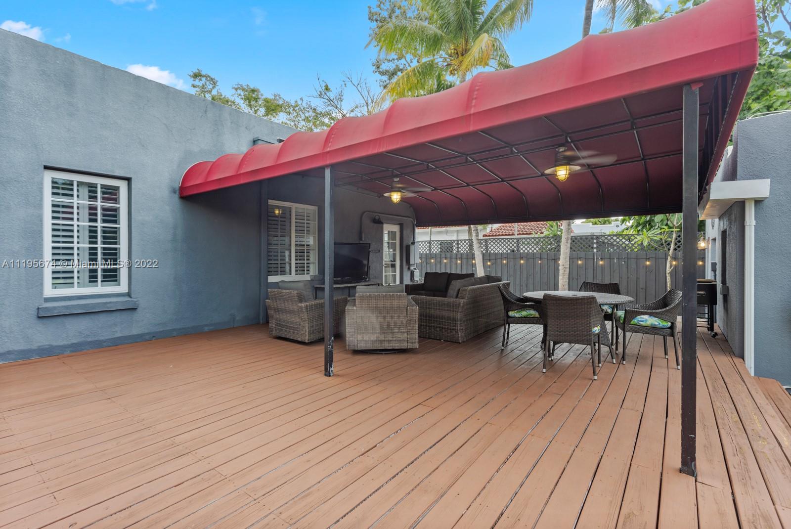 1860 Southwest 11th Street Miami, FL 33135 - Photo 26 of 30 a view of a patio with table and chairs with wooden floor