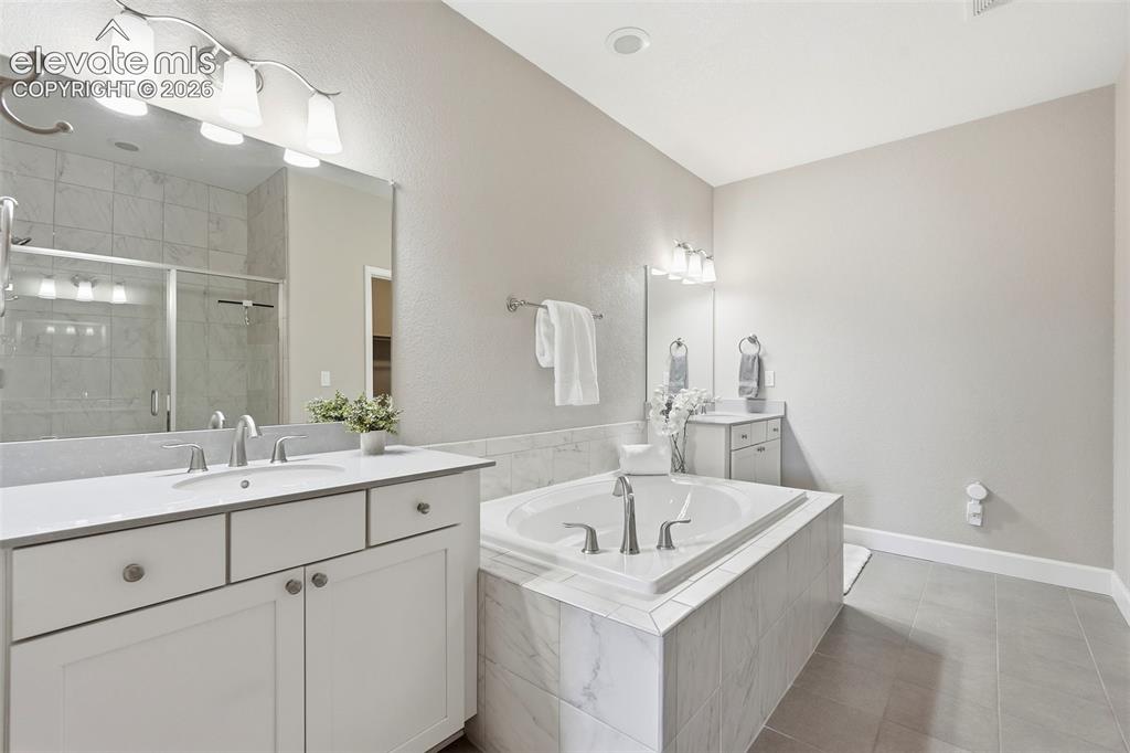 1394 Promontory Bluff View Colorado Springs, CO 80921 - Photo 27 of 47 a bathroom with a sink and a mirror