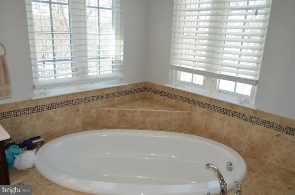 a bath tub sitting in a bathroom next to a window