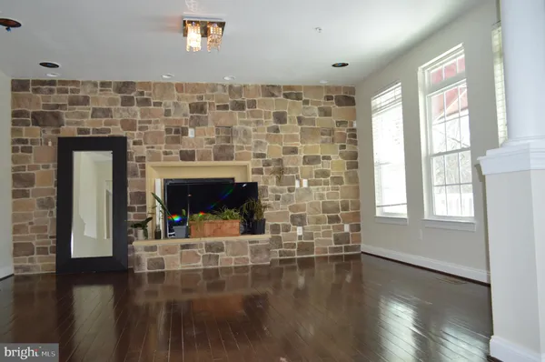 a living room with a fireplace and a wooden floor