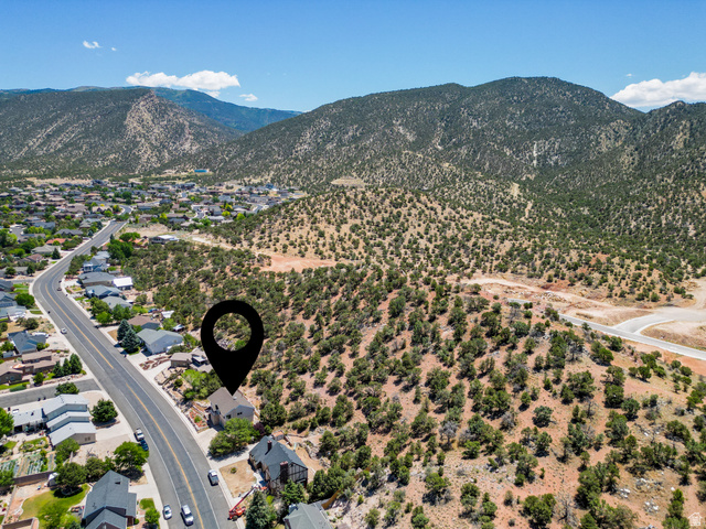 790 East Fiddlers Canyon Road Cedar City, UT 84721 - Photo 25 of 35 Aerial perspective showcasing a property situated along a paved road with surrounding residential structures