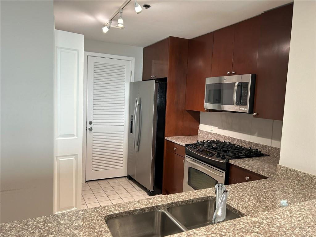 3338 Peachtree Road Northeast, Unit 2102 Atlanta, GA 30326 - Photo 2 of 14 a kitchen with stainless steel appliances granite countertop a refrigerator and a stove top oven