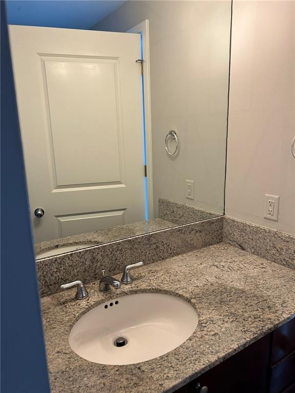 3338 Peachtree Road Northeast, Unit 2102 Atlanta, GA 30326 - Photo 9 of 14 a bathroom with a granite countertop sink and a mirror