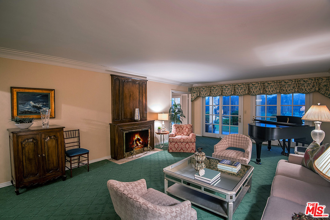 10 Gale Place Santa Monica, CA 90402 - Photo 15 of 46 a living room with furniture a fireplace and a flat screen tv