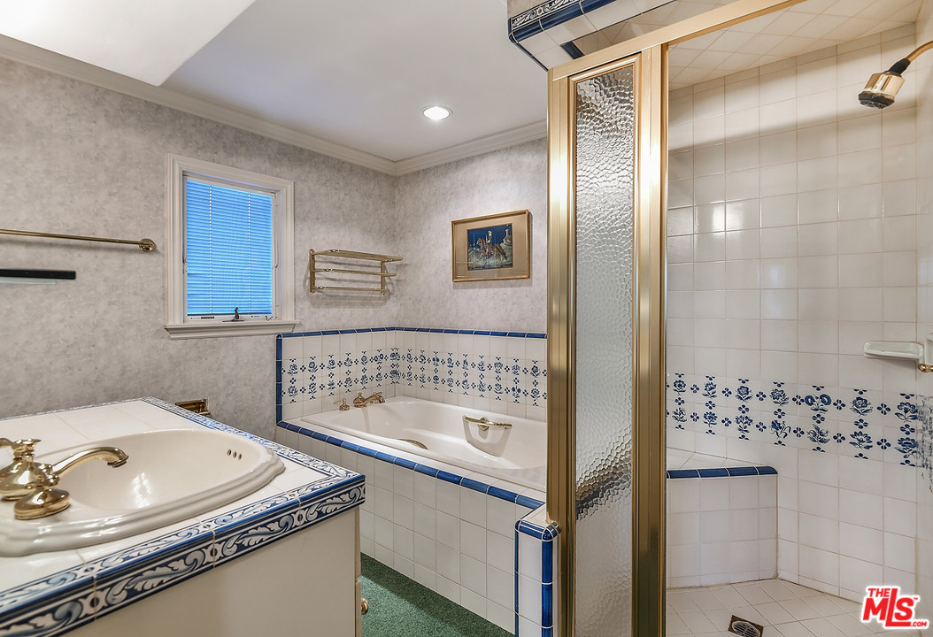 10 Gale Place Santa Monica, CA 90402 - Photo 43 of 46 a bathroom with a granite countertop sink a mirror and shower