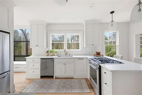 a kitchen with a sink stove and window