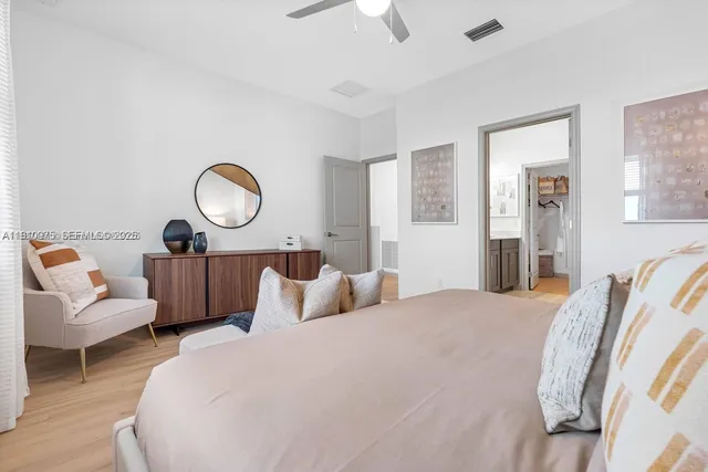 a bedroom with bed and a chandelier
