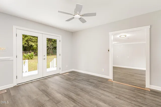wooden floor in an empty room with a window