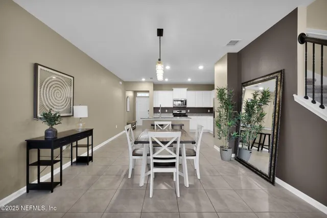 a dining room with furniture and window