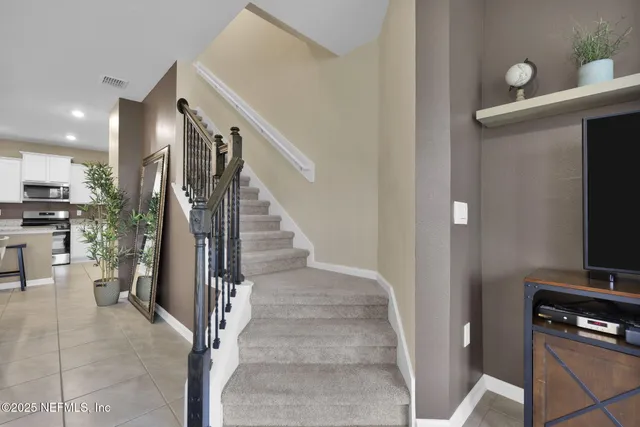 a view of a hallway with workspace and living room