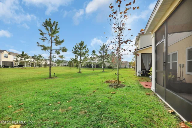 a view of a house with a yard and sitting area