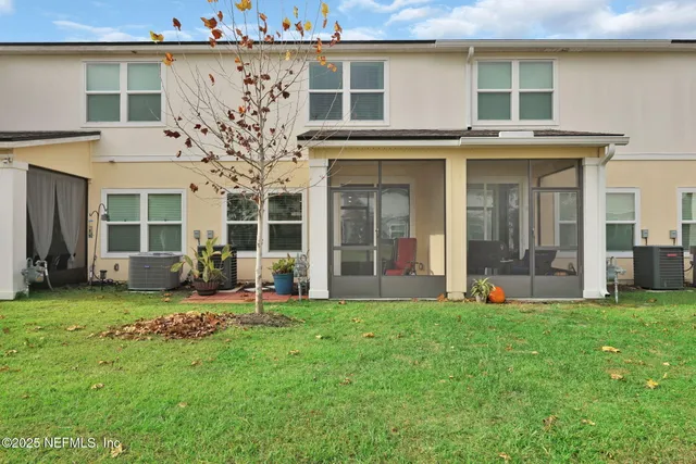 a front view of a house with a garden and plants