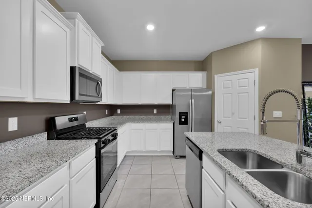 a kitchen with a sink stove and refrigerator