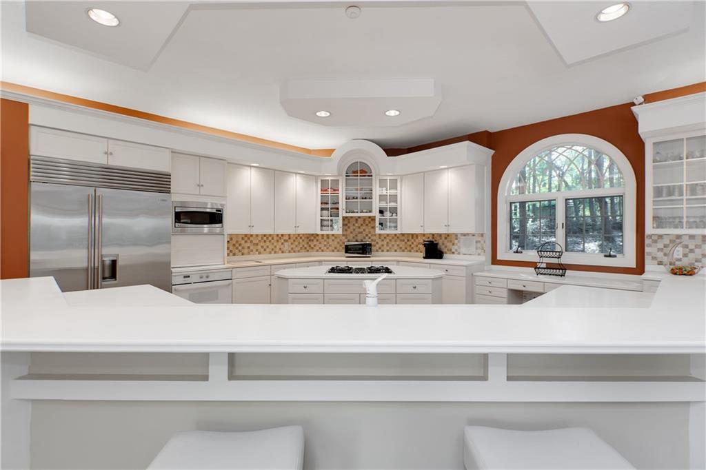 100 Burry Road Bradford Woods, PA 15015 - Photo 6 of 25 a large white kitchen with kitchen island a large window cabinets and a counter space