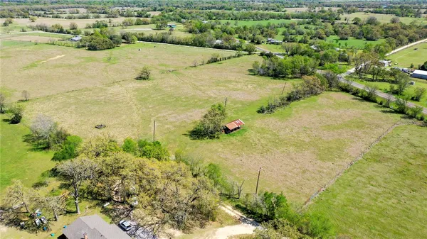 an aerial view of a house with a yard