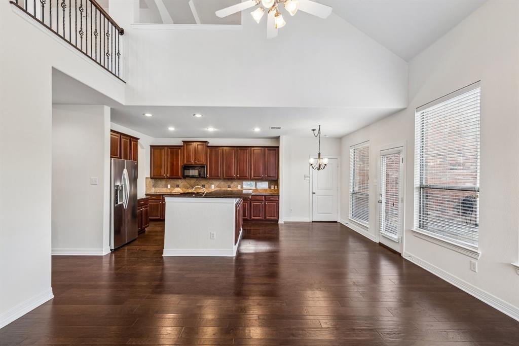960 Remuda Road Frisco, TX 75033 - Photo 33 of 39 Expansive living area with wood-finish flooring, vaulted ceilings, and large windows