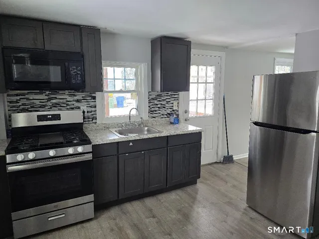 a kitchen with a refrigerator stove and microwave