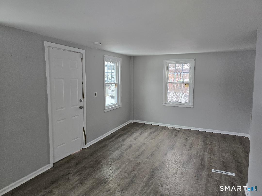 116 Rosette Street Waterbury, CT 06708 - Photo 4 of 7 an empty room with windows