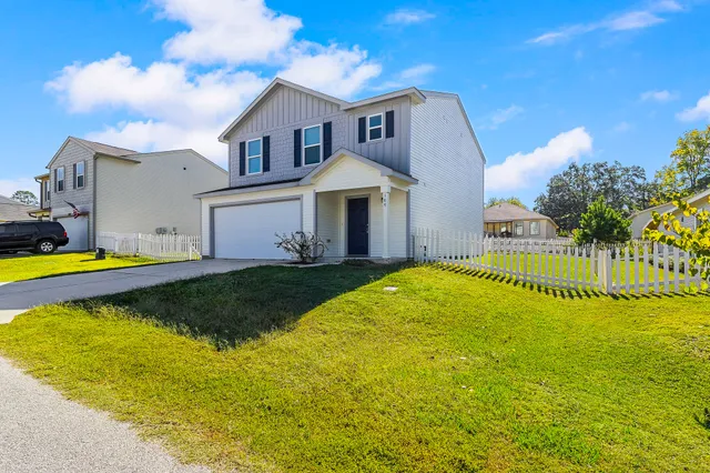 a view of a house with swimming pool and a yard