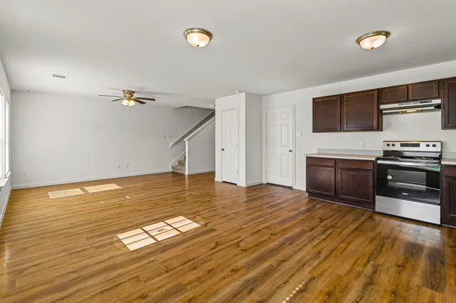 a view of a kitchen with a sink and a refrigerator