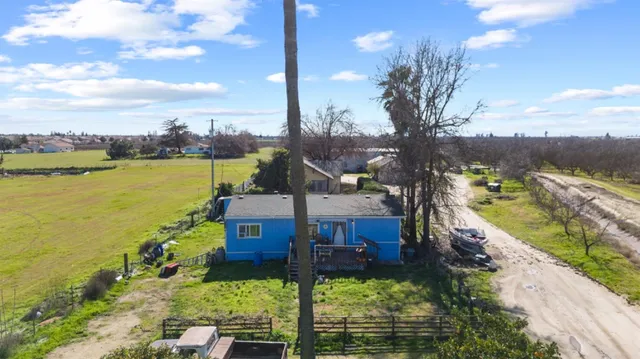 a aerial view of a house with swimming pool and lake view