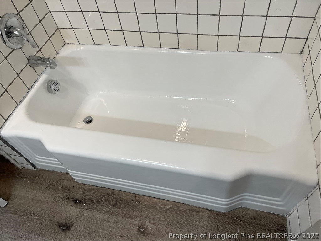 1215-1219 Camden Road Fayetteville, NC 28306 - Photo 15 of 25 a bathroom with a white bath tub and a shower