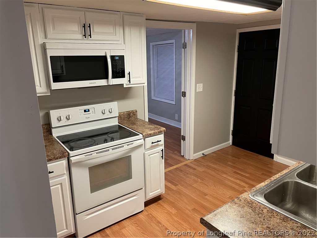 1215-1219 Camden Road Fayetteville, NC 28306 - Photo 16 of 25 a kitchen with a stove and a microwave