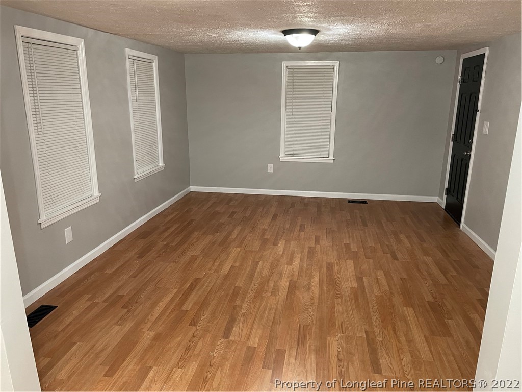 1215-1219 Camden Road Fayetteville, NC 28306 - Photo 24 of 25 a view of an empty room with wooden floor and a window