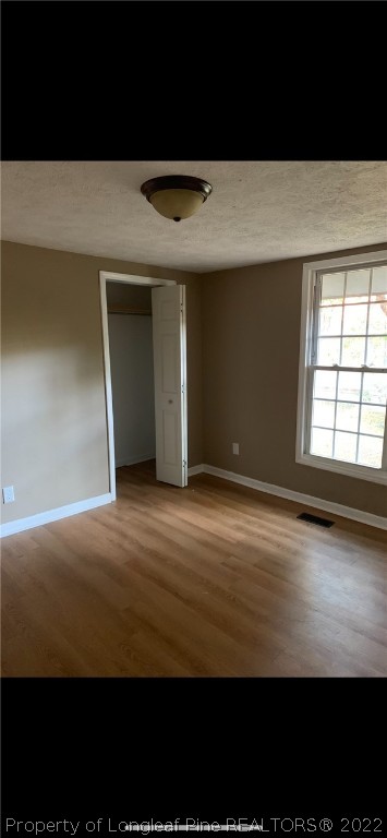 1215-1219 Camden Road Fayetteville, NC 28306 - Photo 6 of 25 a view of an empty room with wooden floor and a window