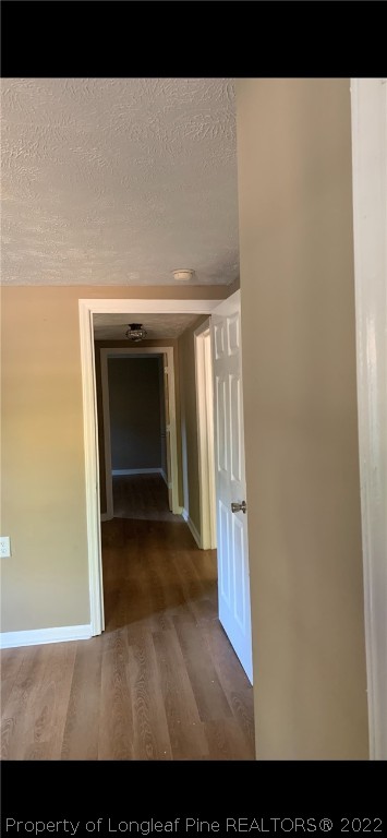 1215-1219 Camden Road Fayetteville, NC 28306 - Photo 7 of 25 a view of an empty room with wooden floor and a window
