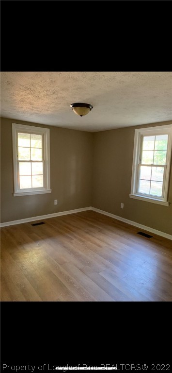 1215-1219 Camden Road Fayetteville, NC 28306 - Photo 9 of 25 a view of empty room with wooden floor and fan