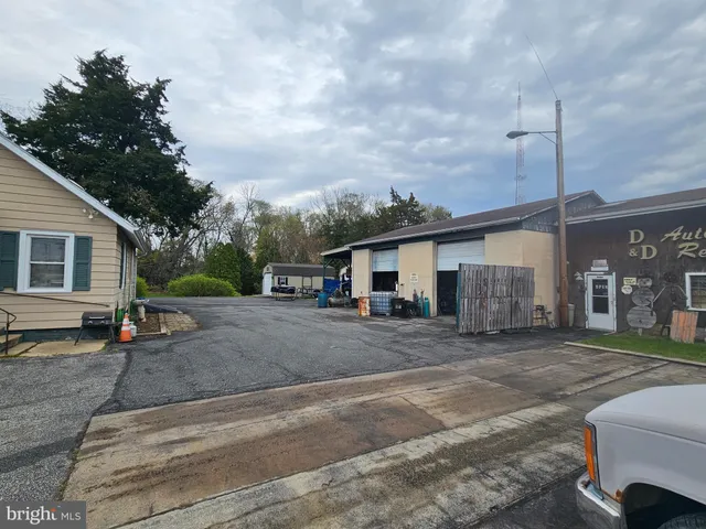 a view of a house with wooden fence