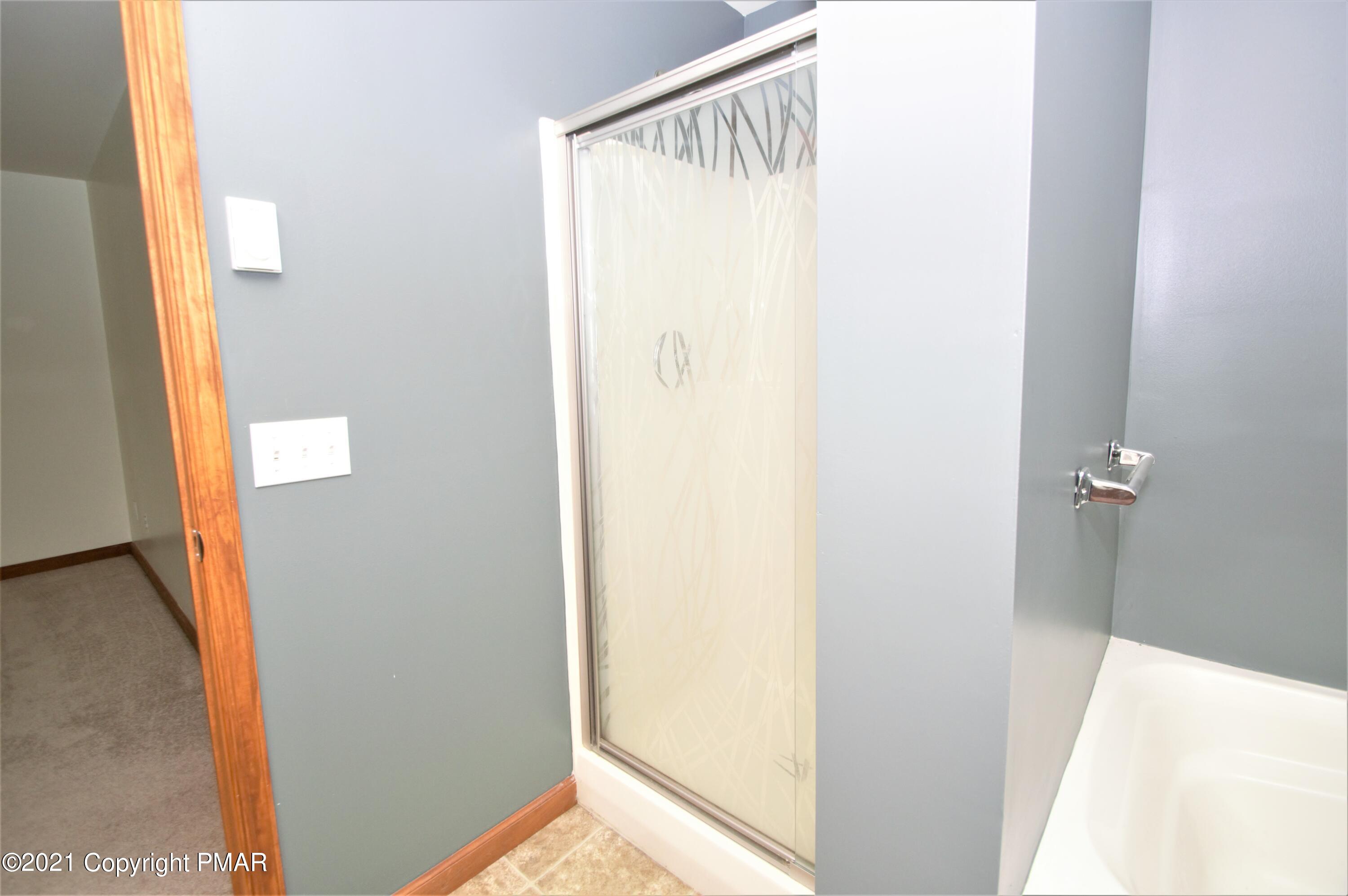 136 Canterbury Road Bushkill, PA 18324 - Photo 20 of 32 a bathroom with a shower and a door