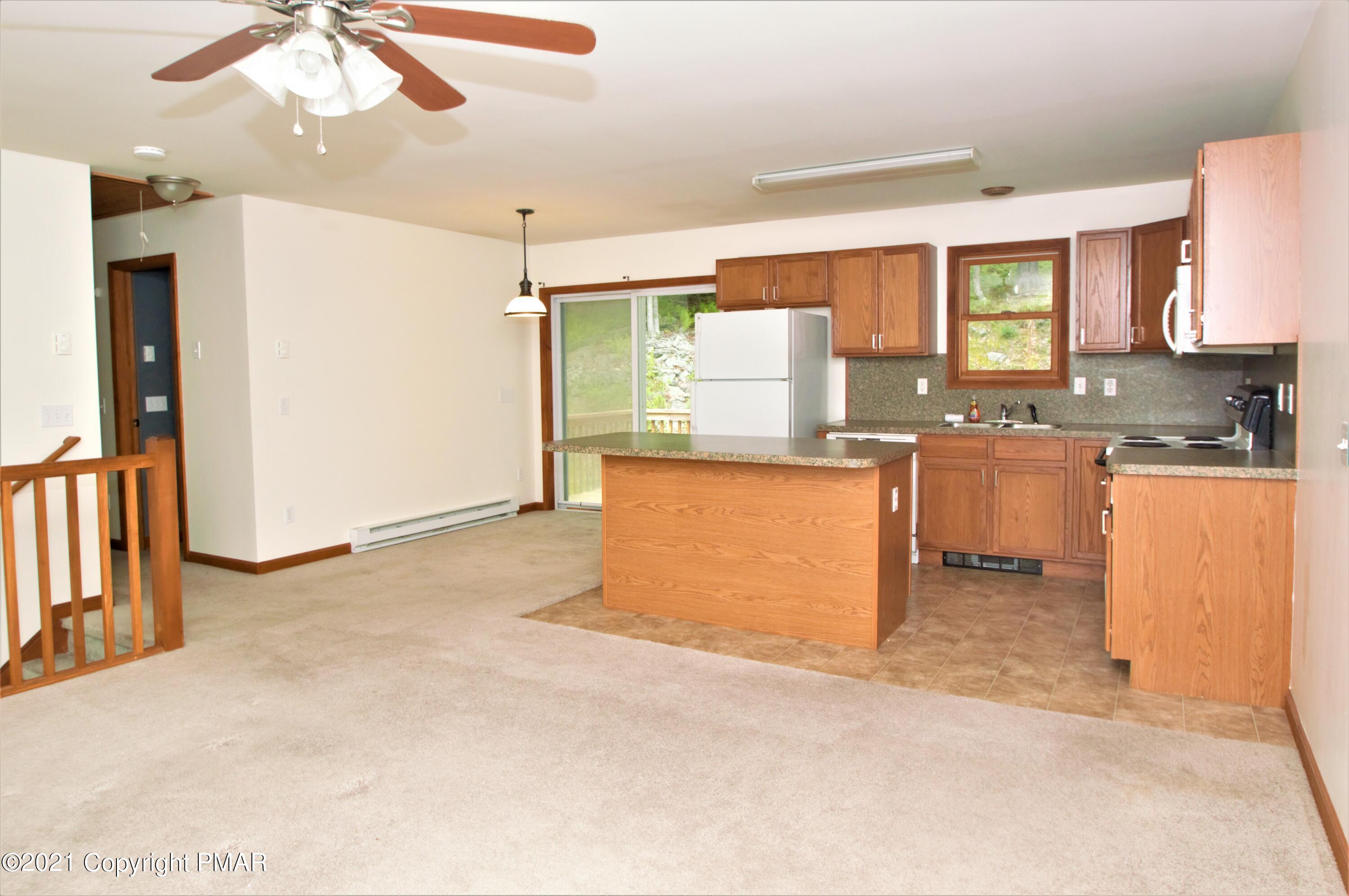 136 Canterbury Road Bushkill, PA 18324 - Photo 3 of 32 a kitchen with stainless steel appliances granite countertop a sink stove and refrigerator