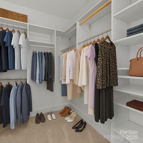 a view of walk in closet with clothes and shoes