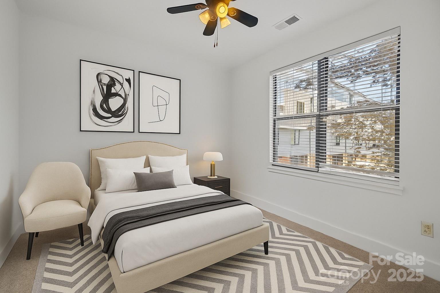 927 East 8th Street Charlotte, NC 28204 - Photo 25 of 35 a bedroom with a bed and a chandelier