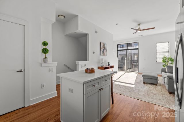 a kitchen with a sink cabinets and wooden floor