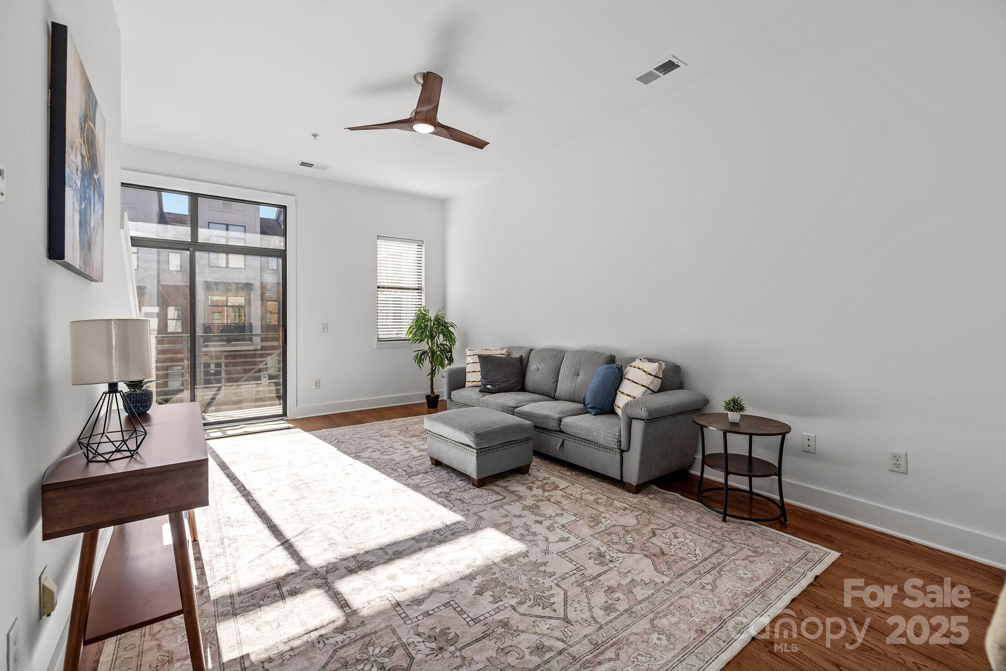 927 East 8th Street Charlotte, NC 28204 - Photo 9 of 35 a living room with furniture and a window