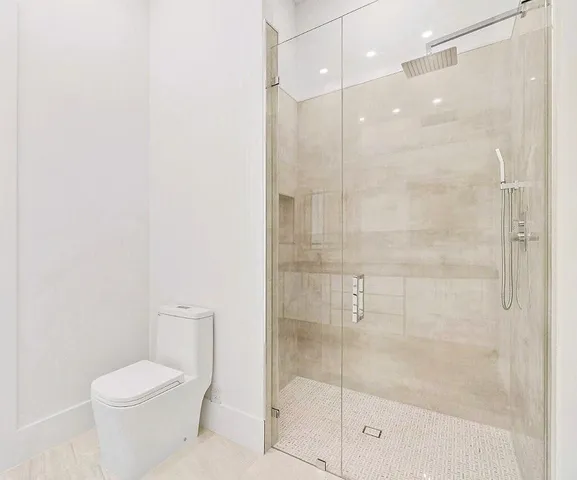a bathroom with a toilet and a shower