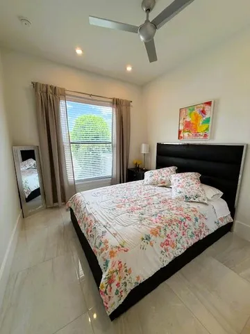 a bedroom with a bed and window