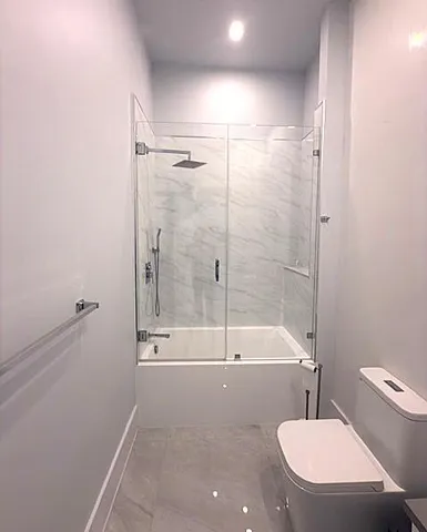a bathroom with a toilet and a shower