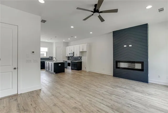 a view of a kitchen with a sink and a refrigerator