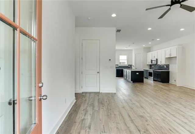 a kitchen with stainless steel appliances granite countertop a sink stove and cabinets