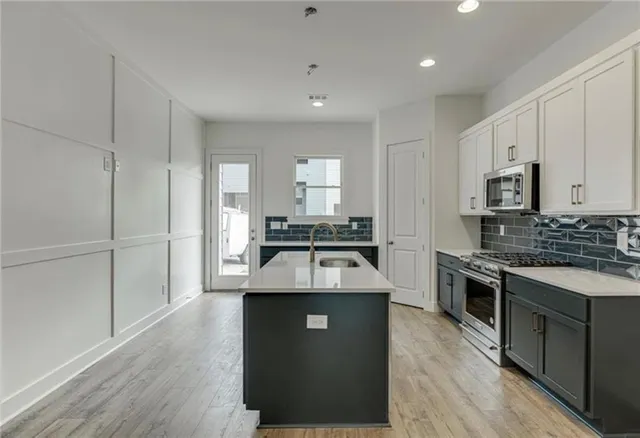 a kitchen with a sink stove and microwave