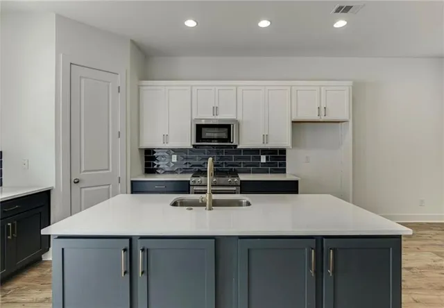 an empty room with a ceiling fan and carpet