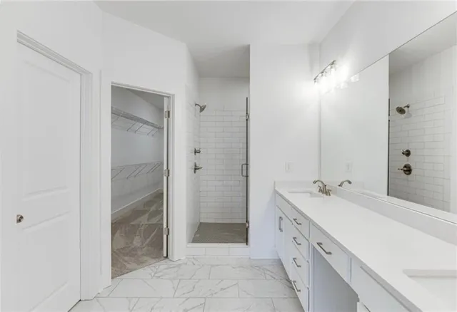 a spacious bathroom with a double vanity sink mirror and double